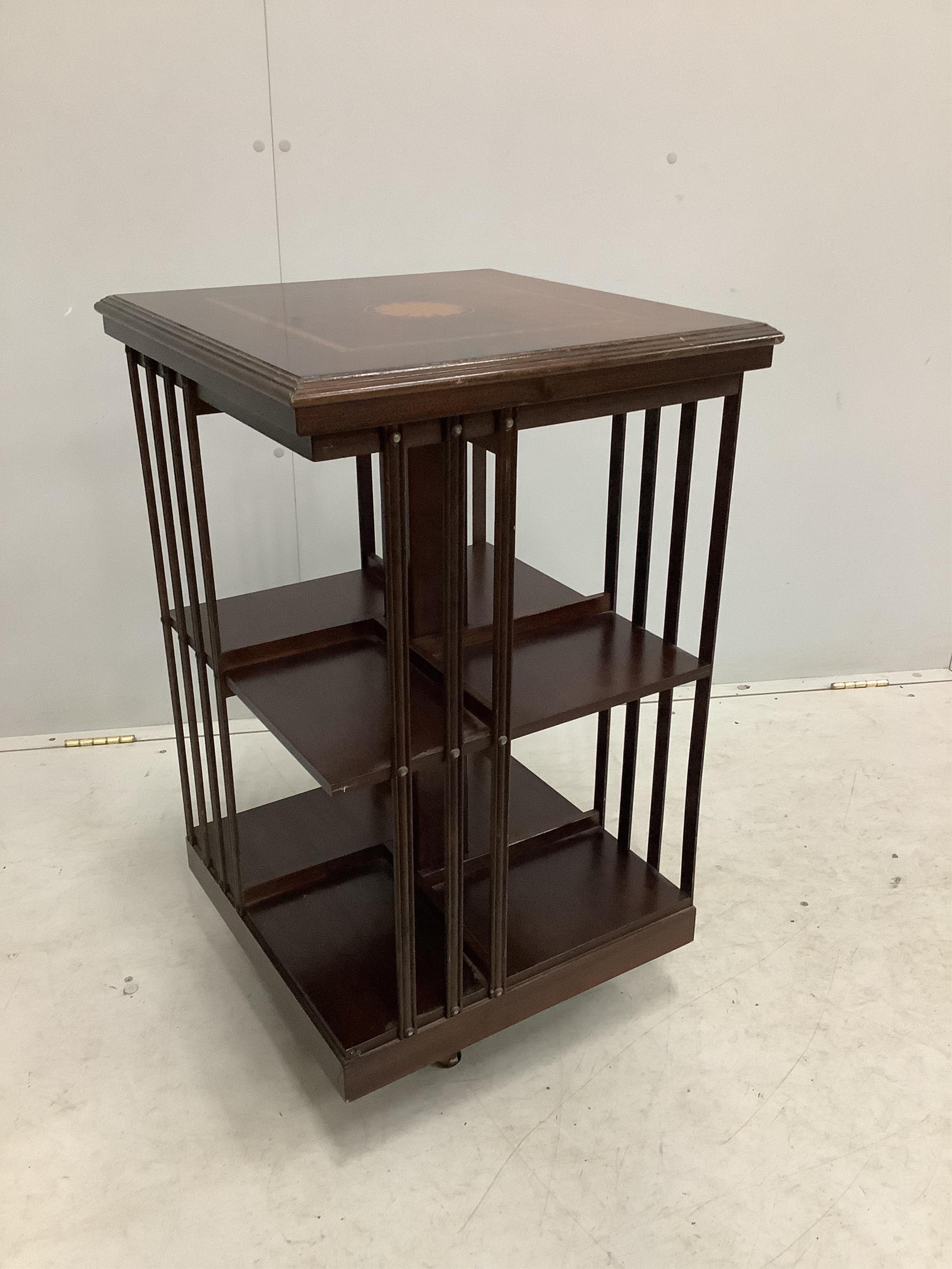 An Edwardian style inlaid mahogany revolving bookcase, width 48cm, depth 48cm, height 79cm. Condition - fair